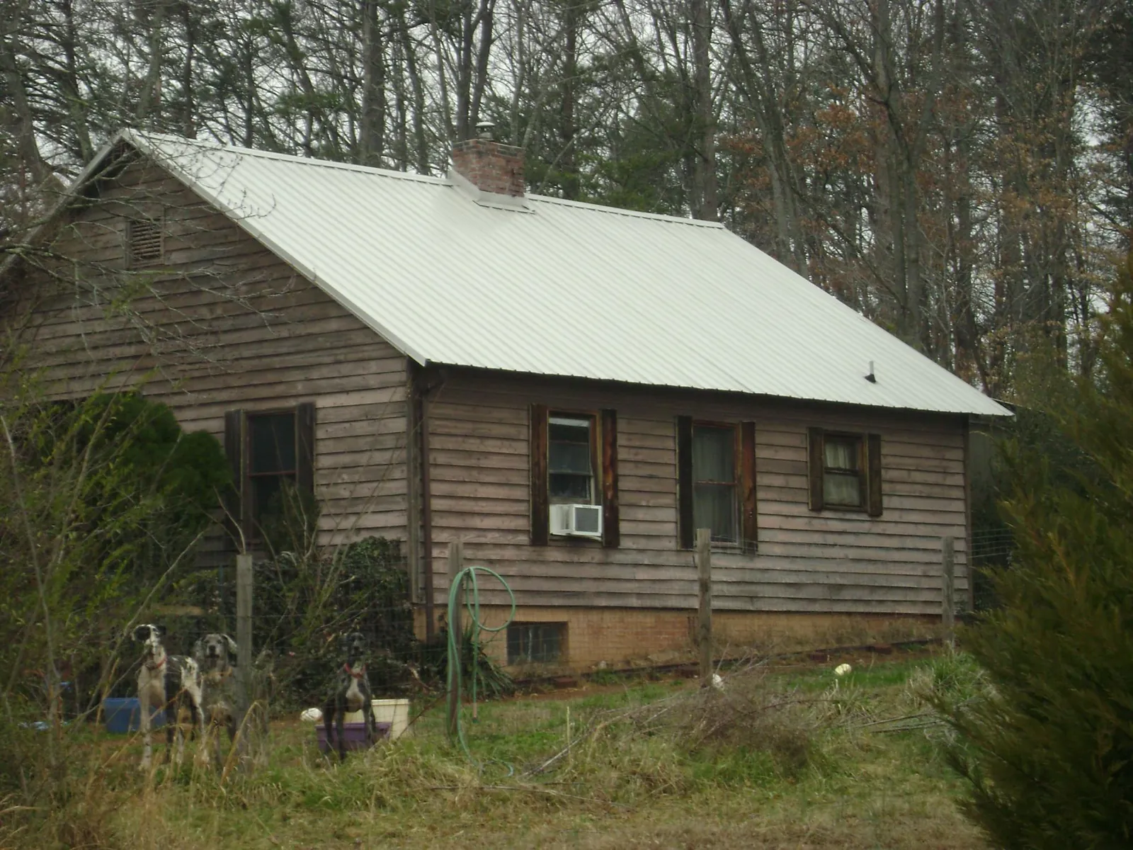White metal roof on an old wood sided farmhouse, from a Metal Roof Installation job in Fiatt